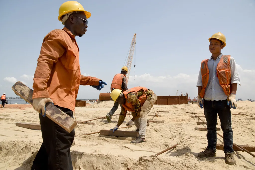 Chinese and Ivorian engineers work on the construction of a container terminal in Abidjan.