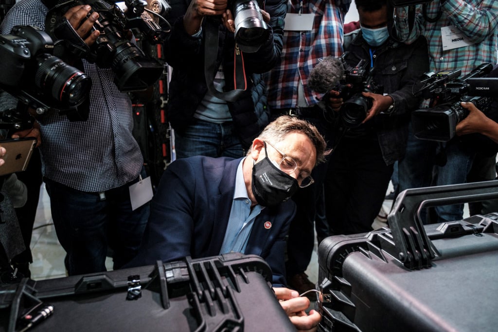 Photographers crowd round as a representative of the Global Partnership for Ethiopia Consortium opens a suitcase containing the group's bid at the Ethiopian telecoms auction in April.