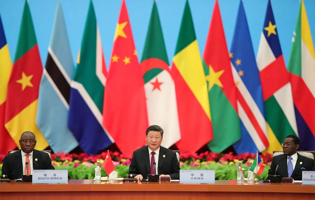 President Xi Jinping of China presides at the FOCAC conference in 2018, with Chinese and African flags behind him.