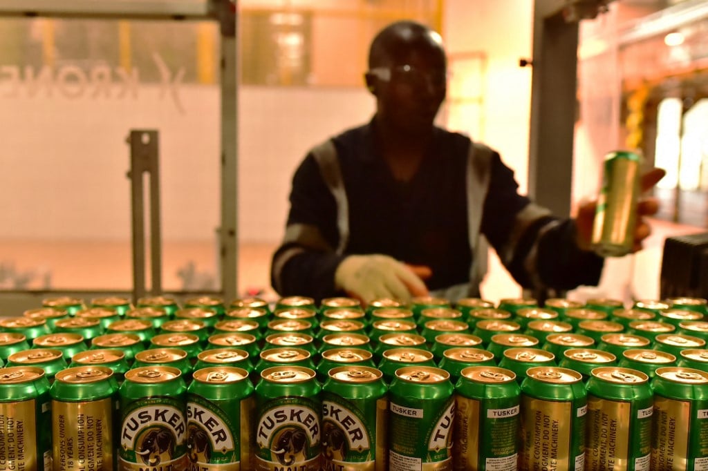 An employee of the East African Breweries Limited sorts canned beers.