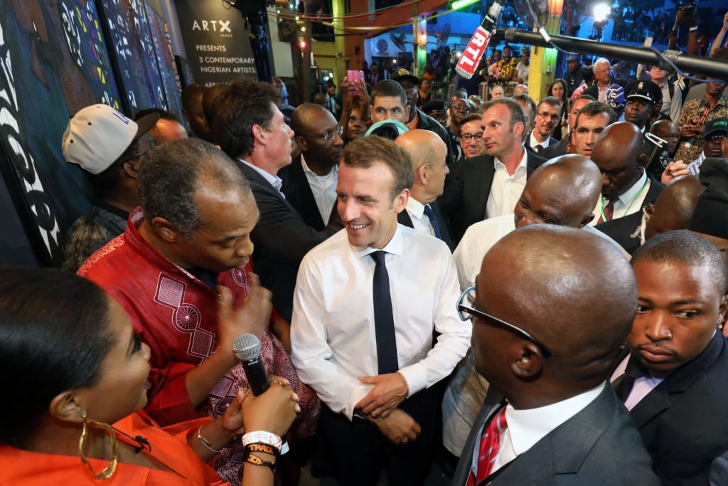 French President Emmanuel Macron surrounded by French and local people at the Afrika Shrine nightclub in Lagos.