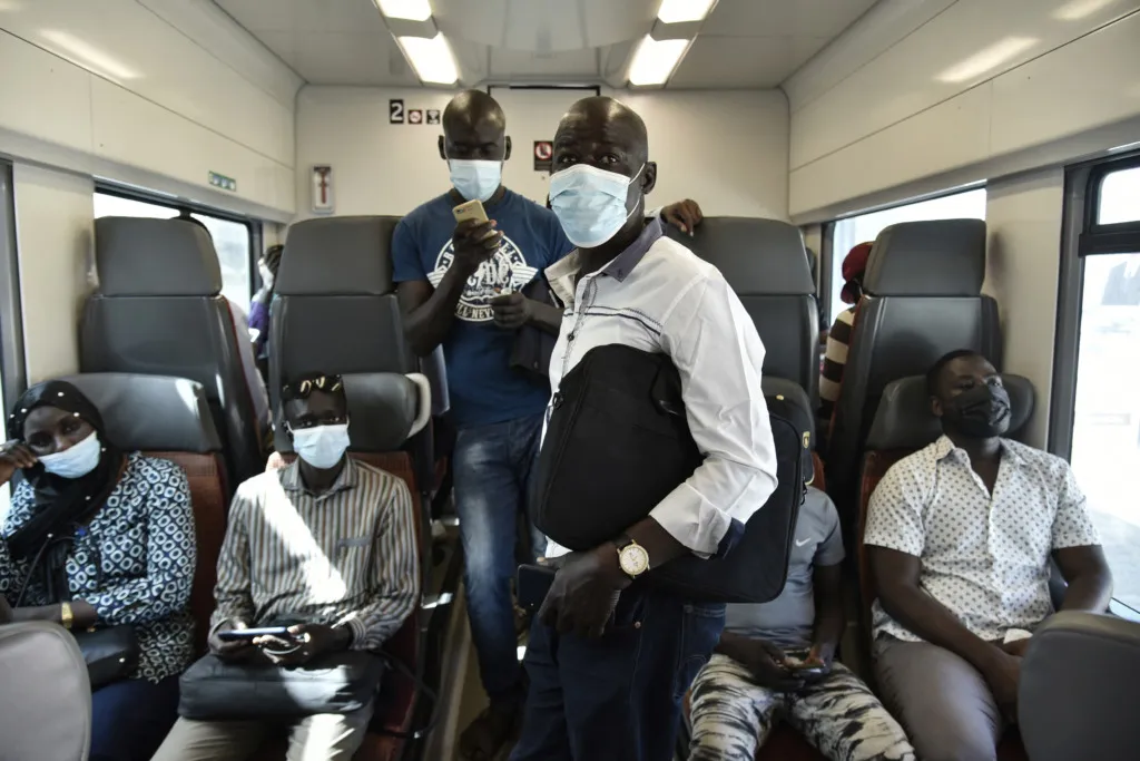 Passengers on a regional express train departing Dakar's central station.