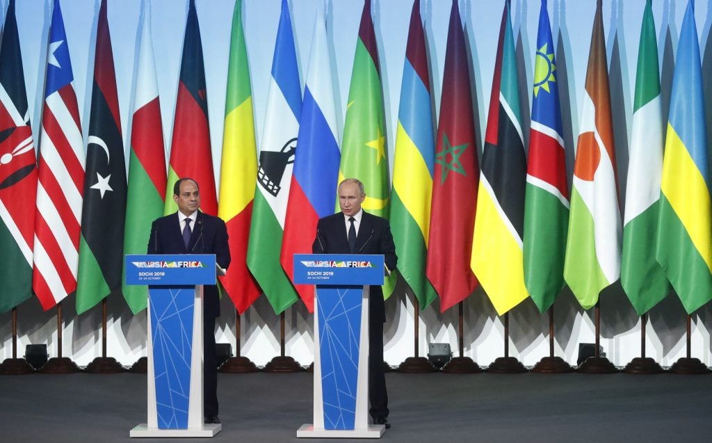 Russia's President Vladimir Putin and Egypt's President Abdel Fattah al-Sisi with African flags in the background